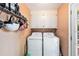 This laundry room features a washer, a dryer, and storage cabinets at 308 Ashley Dr, Summerville, SC 29485