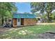 Charming shed with double doors, a single door, and a teal metal roof at 308 Ashley Dr, Summerville, SC 29485