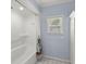 Bathroom with white tile flooring, blue walls, and shower/tub combo at 309 Padgett Loop, Walterboro, SC 29488