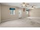 Spacious bonus room with carpet, natural light, and dual ceiling fans at 309 Padgett Loop, Walterboro, SC 29488