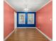 Empty dining room boasts hardwood floors, bright blue accent wall, and modern chandelier at 309 Padgett Loop, Walterboro, SC 29488