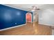 Bright living room with hardwood floors, ceiling fan, and colorful accent wall at 309 Padgett Loop, Walterboro, SC 29488