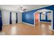 Spacious living room with hardwood floors, archway, ceiling fan, and colorful accent wall at 309 Padgett Loop, Walterboro, SC 29488