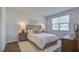 Comfortable main bedroom with soft lighting, stylish decor, and a large window offering a tranquil view at 316 Salvia St, Moncks Corner, SC 29461