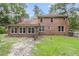Expansive backyard view featuring a brick home with multiple windows providing ample natural light at 320 Compton Xing, Summerville, SC 29485