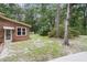 Exterior of brick home with a rear entry door and mature landscaping creating a private backyard at 320 Compton Xing, Summerville, SC 29485