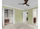 A green bedroom shows closet doors, a ceiling fan, and an ensuite bathroom at 320 Compton Xing, Summerville, SC 29485