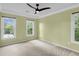 This bedroom features fresh paint, a ceiling fan, and three windows that allow lots of natural light at 320 Compton Xing, Summerville, SC 29485