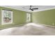 A bright bedroom featuring fresh paint, carpet flooring, a ceiling fan, white trim, and two windows at 320 Compton Xing, Summerville, SC 29485