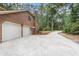 Exterior view showcasing an attached garage, brick home, and a long driveway at 320 Compton Xing, Summerville, SC 29485
