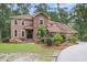 Charming two-story brick home with a well-manicured front lawn and mature landscaping at 320 Compton Xing, Summerville, SC 29485