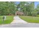 Traditional home with a long driveway, manicured lawns, and mature trees providing privacy at 320 Compton Xing, Summerville, SC 29485