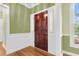 Warm foyer featuring hardwood floors, green walls with white trim, and a welcoming entrance at 320 Compton Xing, Summerville, SC 29485