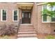 Close-up of the front entrance with brick steps, a dark wood door, and decorative details at 320 Compton Xing, Summerville, SC 29485
