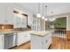 Bright kitchen features granite countertops, white cabinets, stainless steel appliances, and an island at 320 Compton Xing, Summerville, SC 29485
