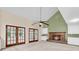 Living room boasting a brick fireplace, hardwood trim, ceiling fan, and French doors at 320 Compton Xing, Summerville, SC 29485