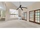 Open living room with ceiling fan, French doors, staircase, and view into the kitchen at 320 Compton Xing, Summerville, SC 29485