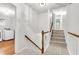 Carpeted staircase with white railing and wooden banister leading to the upper level at 320 Compton Xing, Summerville, SC 29485