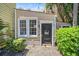 Exterior shot featuring a door and window surrounded by lush green bushes at 33 Pitt St # 3, Charleston, SC 29401