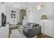 Cozy living room with a grey sectional sofa, exposed brick, and a window for natural light at 33 Pitt St # 3, Charleston, SC 29401