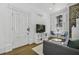 Bright living room featuring a white doorframe, a flat-screen TV, and a view to the outside at 33 Pitt St # 3, Charleston, SC 29401