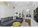 Open living space with hardwood floors and decor that leads to the kitchen, natural light throughout at 33 Pitt St # 3, Charleston, SC 29401