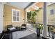 Cozy porch with seating area, classic railing, and view of neighboring houses at 33 Pitt St # 3, Charleston, SC 29401