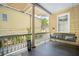 Welcoming porch with a porch swing, classic railing, and view of neighboring houses at 33 Pitt St # 3, Charleston, SC 29401