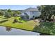 Expansive backyard featuring lush greenery, screened porch, patio, and serene lake view at 3310 Hartwell St, Johns Island, SC 29455