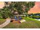 Lush backyard featuring mature trees, a firepit, and a brick patio, perfect for outdoor gatherings at 3310 Hartwell St, Johns Island, SC 29455