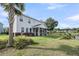 Spacious backyard with palm trees, screened porch, and tranquil water views enhancing outdoor living at 3310 Hartwell St, Johns Island, SC 29455