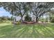 Shaded backyard with mature trees, green grass and comfortable hammock for relaxation at 3310 Hartwell St, Johns Island, SC 29455