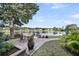 Backyard brick patio overlooking the water, complete with wrought iron table and lush tropical plants at 3310 Hartwell St, Johns Island, SC 29455