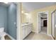 Bathroom boasts a double vanity with granite counters, neutral tile floors and blue accent wall at 3310 Hartwell St, Johns Island, SC 29455