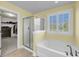 Bright bathroom features a tub, glass shower and a large window providing natural light at 3310 Hartwell St, Johns Island, SC 29455
