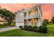 Two-story home featuring a second story balcony, well-manicured lawn, and gray siding at 3310 Hartwell St, Johns Island, SC 29455