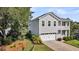 Two-story home with gray siding, a two-car garage, and mature landscaping at 3310 Hartwell St, Johns Island, SC 29455