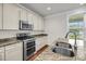 Modern kitchen features stainless steel appliances, granite countertops, and scenic backyard views at 3310 Hartwell St, Johns Island, SC 29455