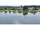 Scenic view of a lake with reflections of nearby homes, trees, and sky at 3310 Hartwell St, Johns Island, SC 29455
