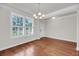 Bright living room with hardwood floors, plantation shutters, and modern lighting at 3310 Hartwell St, Johns Island, SC 29455