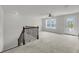 Bright loft space featuring neutral carpet, a ceiling fan, and views of a landscaped yard at 3310 Hartwell St, Johns Island, SC 29455
