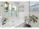 Bright bathroom with a tub, two windows, and lots of greenery at 334 Mossy Oak Way, Mount Pleasant, SC 29464
