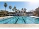 Community swimming pool with palm trees and a beautiful clubhouse in the background at 334 Mossy Oak Way, Mount Pleasant, SC 29464