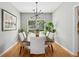 Bright dining room featuring a wooden table, six upholstered chairs, and a modern light fixture at 334 Mossy Oak Way, Mount Pleasant, SC 29464