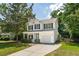 Daytime view of a charming two-story home featuring a cozy front porch, a garage, and landscaped yard at 334 Mossy Oak Way, Mount Pleasant, SC 29464
