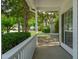Cozy front porch with white railings and view of the street featuring well-maintained landscaping at 334 Mossy Oak Way, Mount Pleasant, SC 29464
