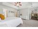 This primary bedroom features soft lighting, carpeted floors, tray ceiling, and ample closet space at 334 Mossy Oak Way, Mount Pleasant, SC 29464