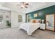 Inviting main bedroom features a tray ceiling, accent wall, large windows, and cozy carpet at 334 Mossy Oak Way, Mount Pleasant, SC 29464
