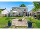 Large backyard featuring a fire pit, patio and well-maintained lawn, perfect for outdoor gatherings at 3364 Middlesboro Ave, Summerville, SC 29485