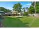 Expansive backyard featuring lush green grass, mature trees, a fire pit area and grill, perfect for outdoor enjoyment at 3364 Middlesboro Ave, Summerville, SC 29485